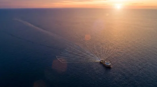 Vue aérienne d'un navire sismique en opération offshore avec équipements d'acquisition de données géophysiques